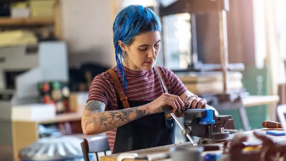 Confident young craftswoman in her workshop