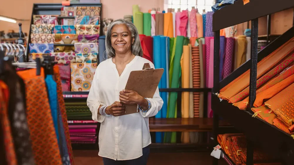 Portrait of a smiling mature fabric shop owner