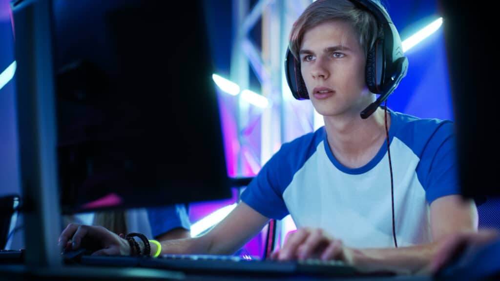 Professional Boy Gamer Plays in Video Game on a eSports Tournament