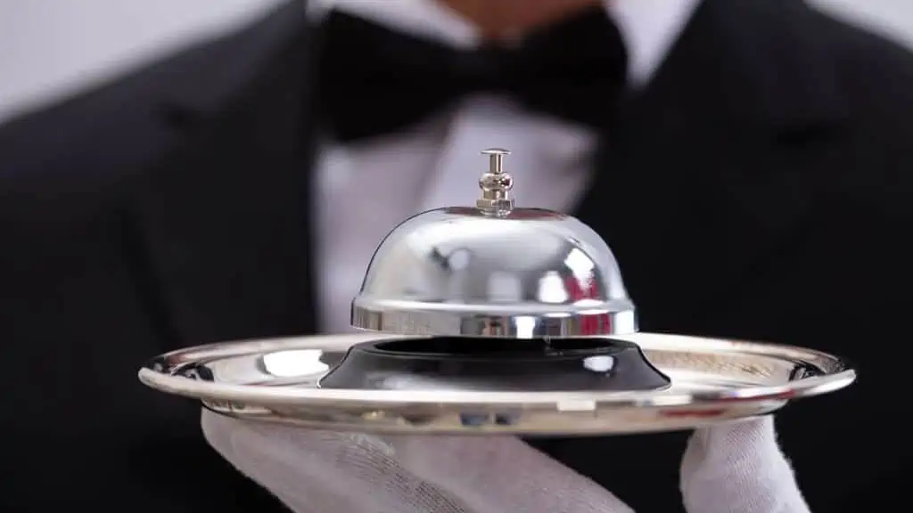Person Holding Service Bell In Plate