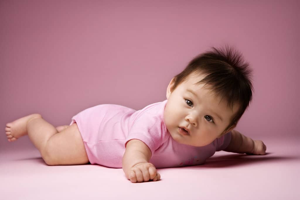 Baby lying on stomach.