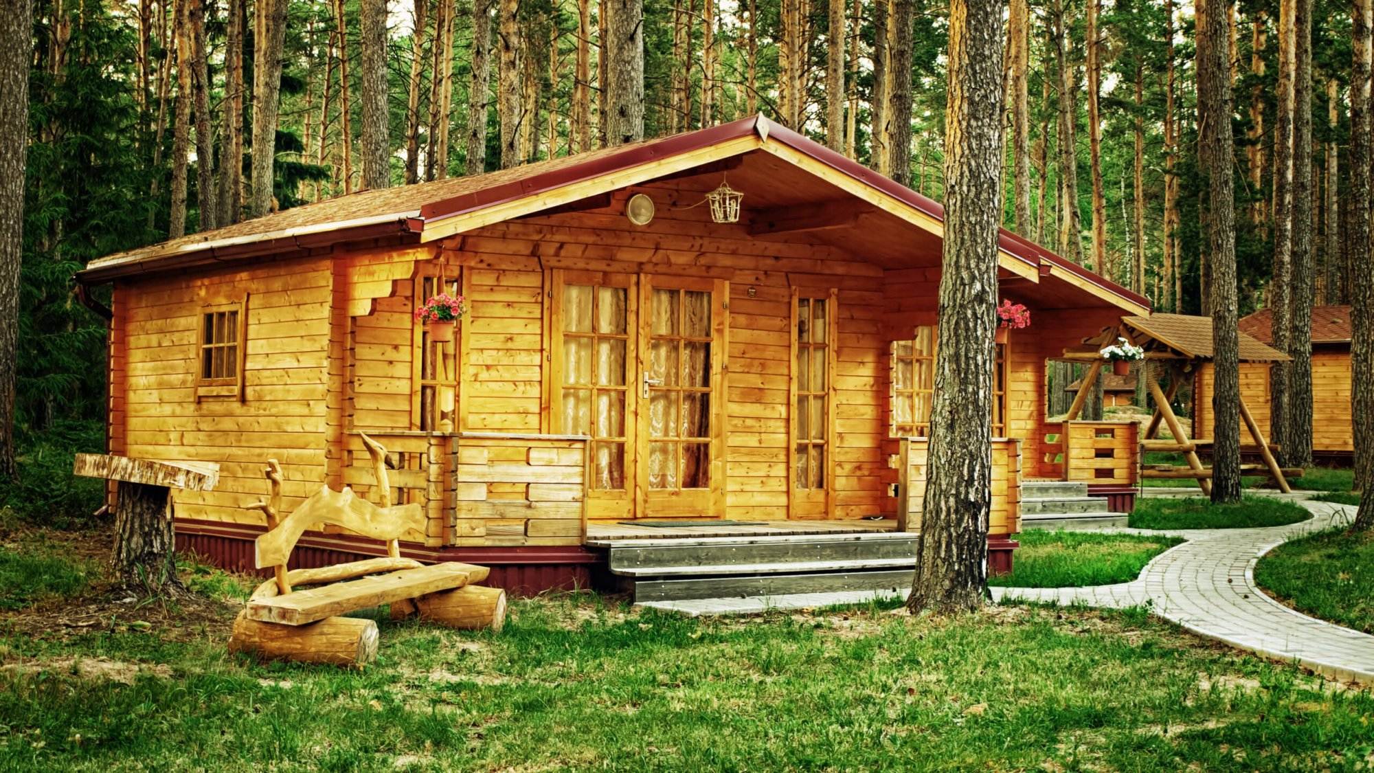 Wooden cottages with flowers in the pine forest