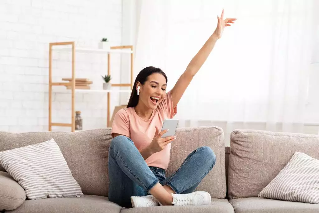 Girl wearing headphones enjoying music with phone