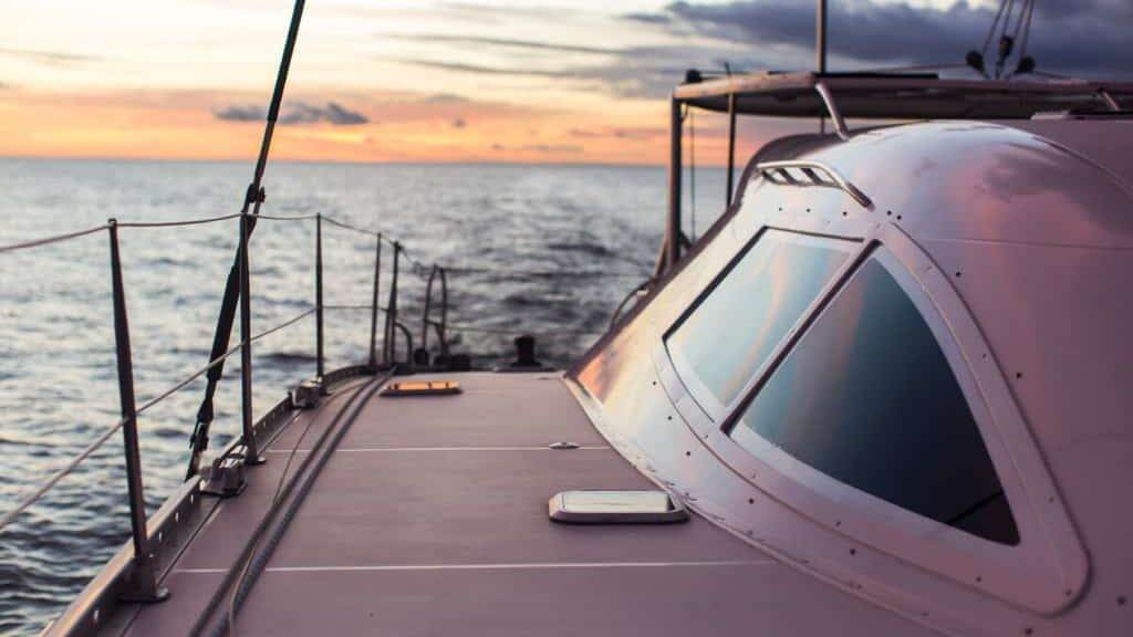 Sailing ship luxury yacht boat in the Sea during amazing sunset.