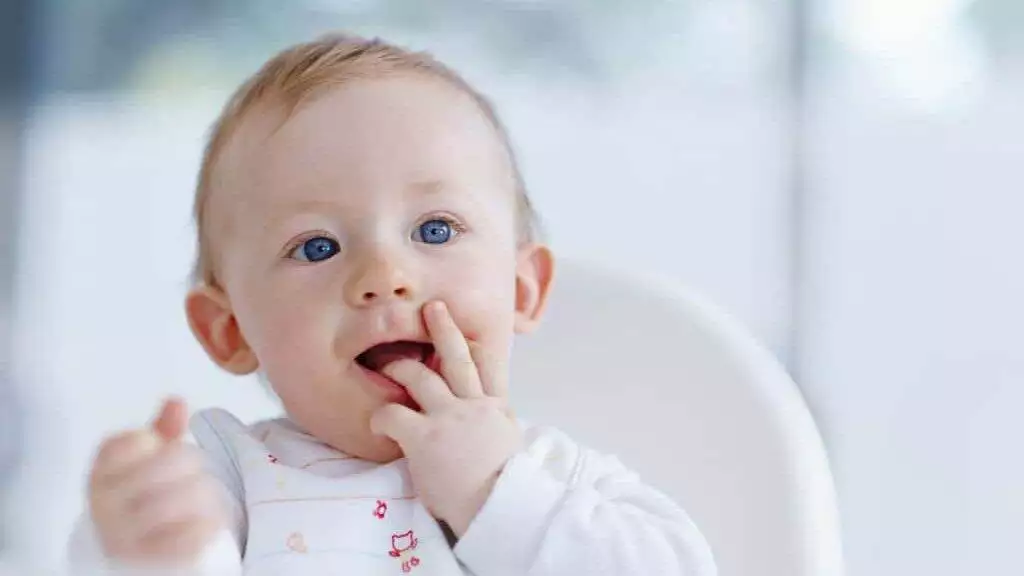 Itchy teeth. Cropped image of a cute baby boy with a finger in his mouth