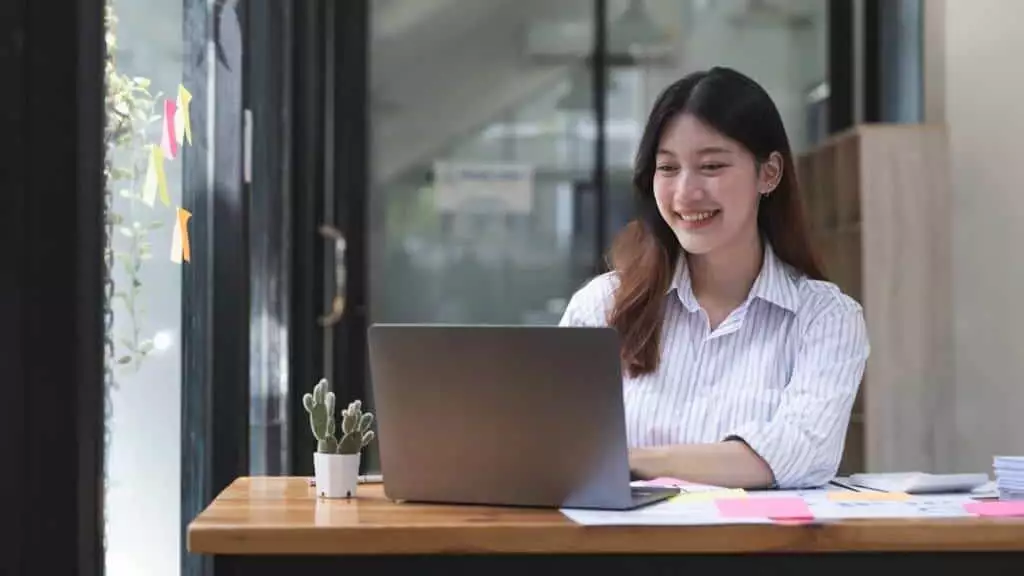Attractive asian woman working on laptop computer for accounting bookkeeping paperowork