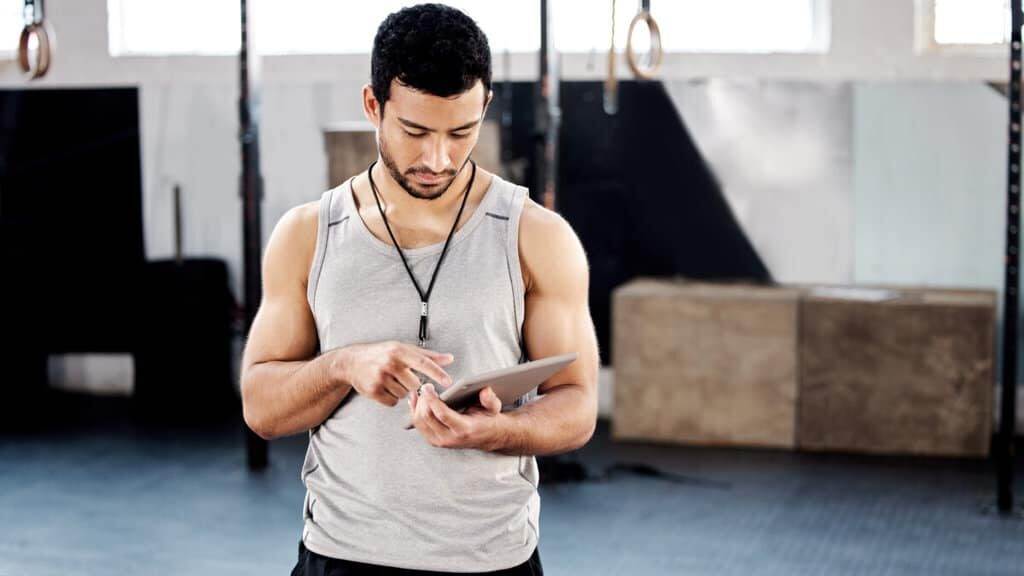 Shot of a handsome young man using a digital tablet at the gym.