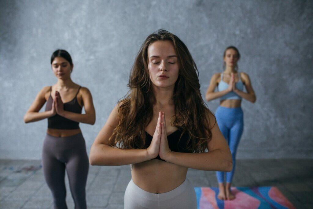 Photograph of Women Meditating with Their Eyes Closed