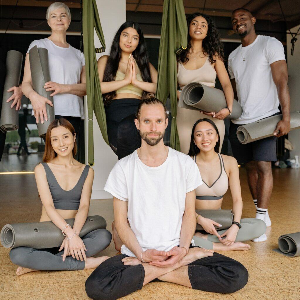 A Group of People in Activewear while Holding Yoga Mats