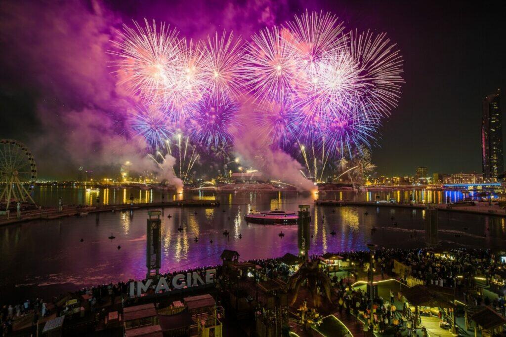 Fireworks Display over City Buildings during Night Time