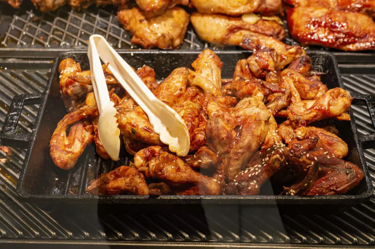 A tray of chicken wings on a grill.