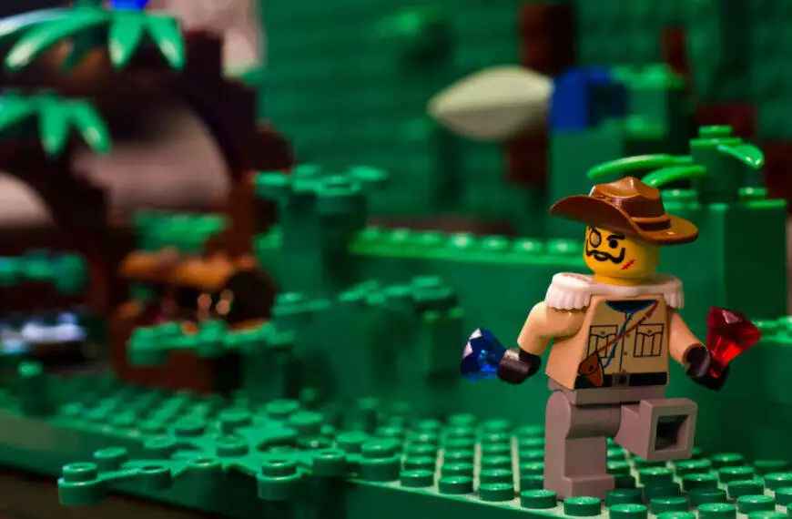 A Lego figure is adventurously navigating through a dense jungle filled with exotic flora and fauna.